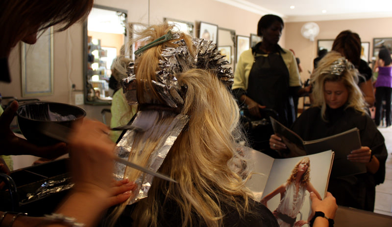 The lenghts people will go to suit the 'ideal', such as dying their hair. Chantel Botes (23) is depicted here, having chemicals put into her hair by hairdresser Marilise Verhoef.People like Chantel often model their ideal image on those that are depicted in magazines, such as the one Chantel is looking through.